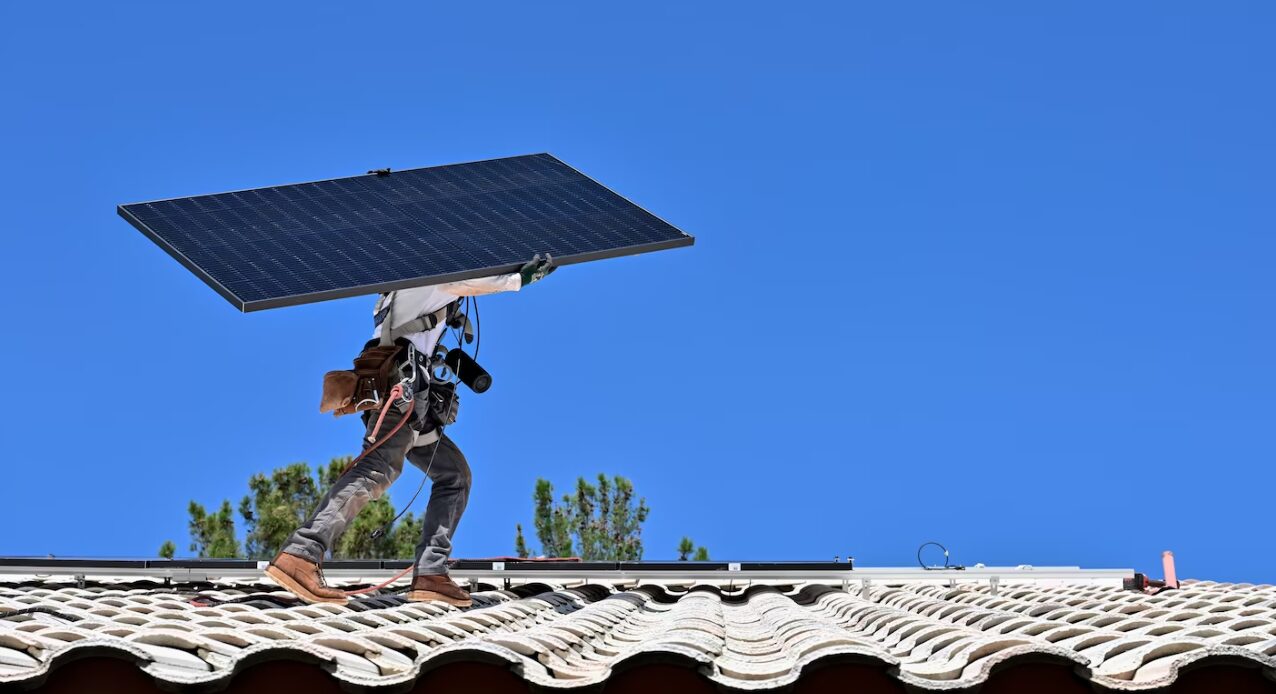 A Sunrun worker in Las Vegas carries a solar panel for installation at a home on Aug. 24. (David Becker for The Washington Post)